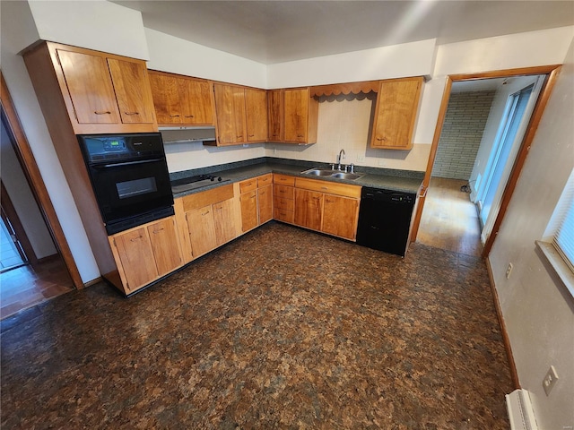 kitchen featuring black appliances, baseboard heating, and sink