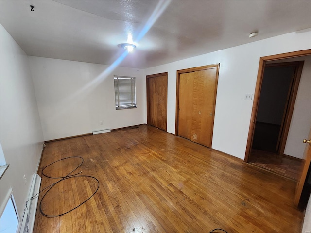 bonus room featuring hardwood / wood-style flooring and baseboard heating