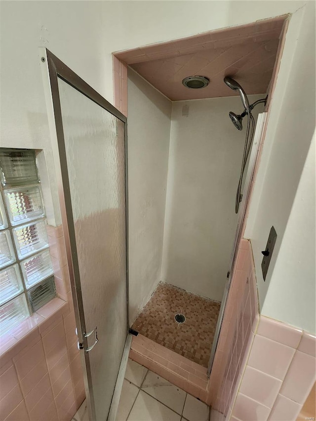 bathroom featuring tile patterned flooring and walk in shower