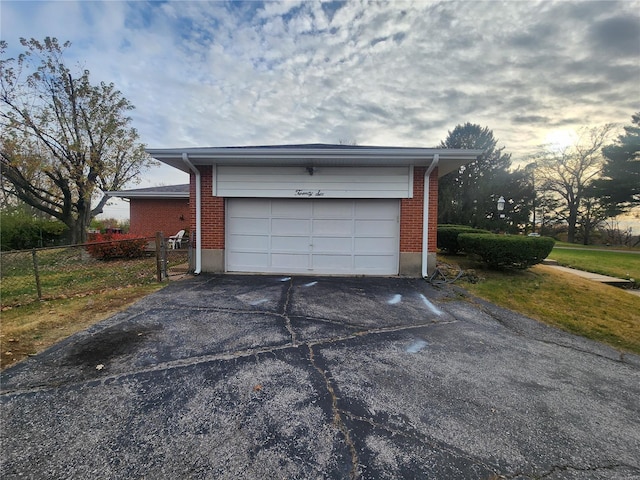 view of garage at dusk