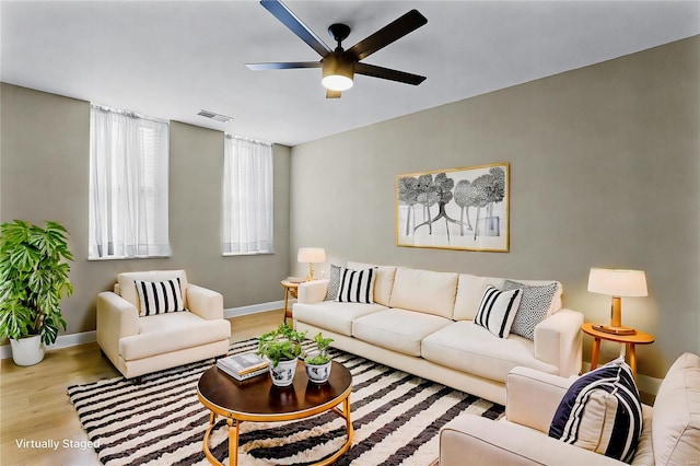 living room featuring ceiling fan and light wood-type flooring