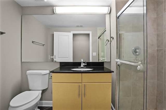 bathroom with vanity, toilet, and walk in shower