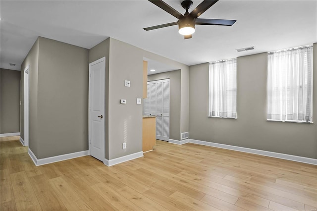 empty room with light hardwood / wood-style floors and ceiling fan