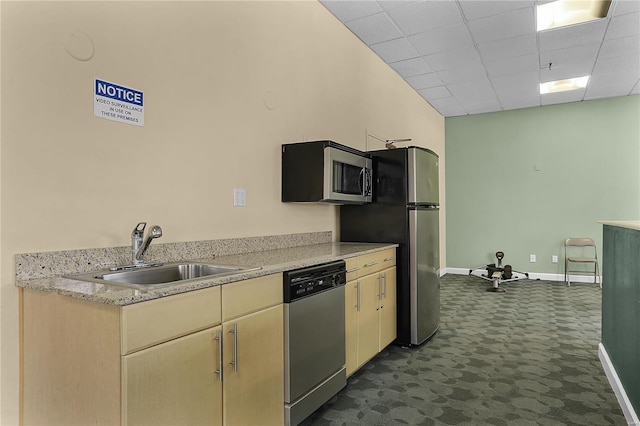 kitchen featuring a paneled ceiling, sink, stainless steel appliances, and dark carpet