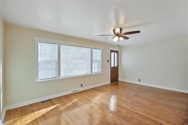 empty room with ceiling fan and wood-type flooring