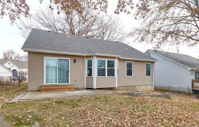 back of house featuring entry steps, roof with shingles, a patio area, and fence