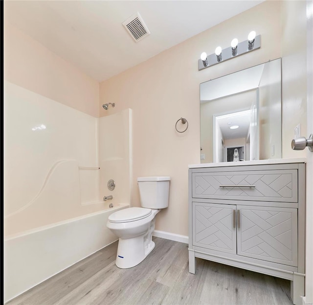 full bathroom featuring visible vents, toilet, shower / bathtub combination, wood finished floors, and vanity