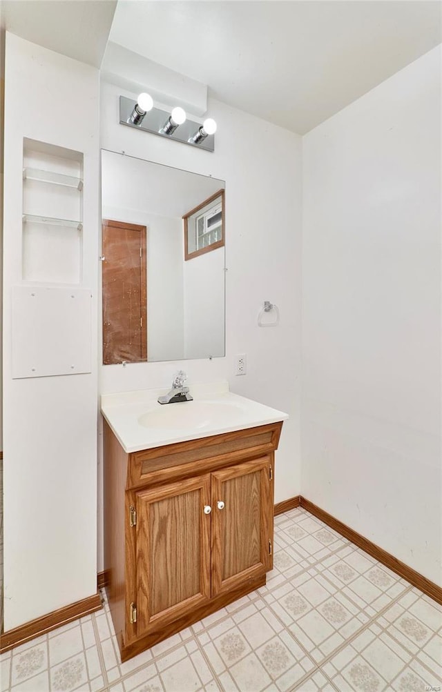 bathroom with tile patterned floors, vanity, and baseboards