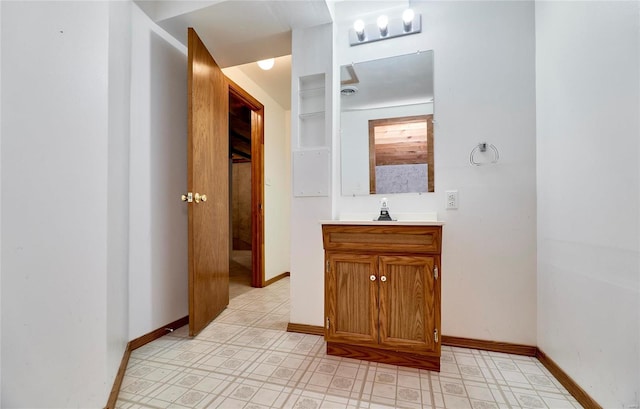 bathroom featuring tile patterned floors, vanity, and baseboards