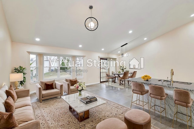 living room featuring lofted ceiling, baseboards, and recessed lighting