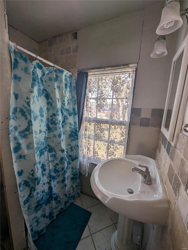 bathroom featuring tile patterned floors, tile walls, and walk in shower