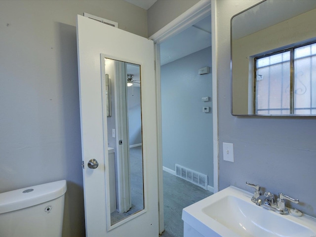 bathroom with ceiling fan, sink, hardwood / wood-style floors, and toilet