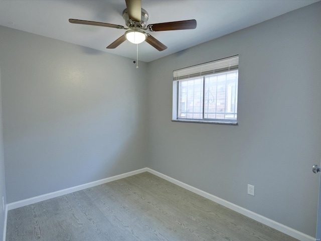 spare room with ceiling fan and light wood-type flooring