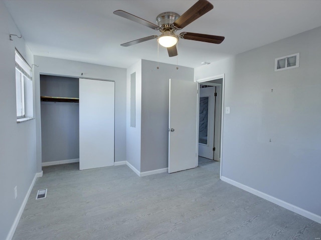 unfurnished bedroom with ceiling fan, a closet, and light hardwood / wood-style floors