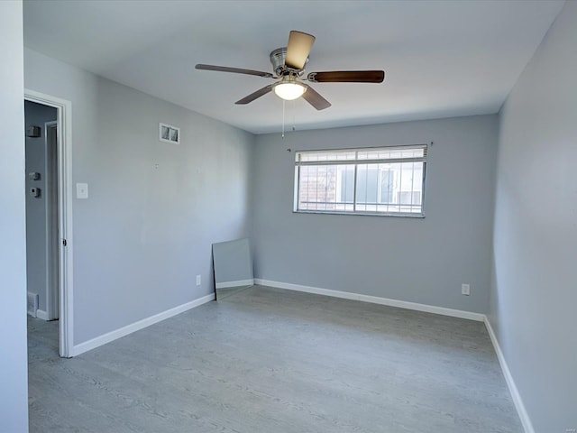 unfurnished room with ceiling fan and light hardwood / wood-style floors