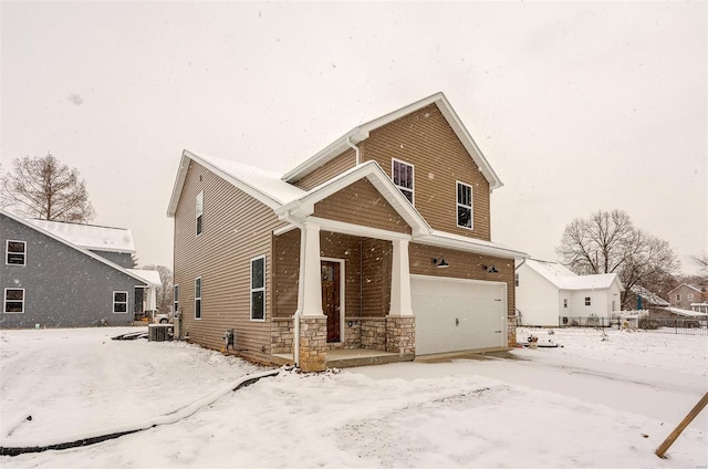 view of front of property with a garage and central air condition unit