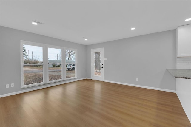 unfurnished living room with light hardwood / wood-style floors