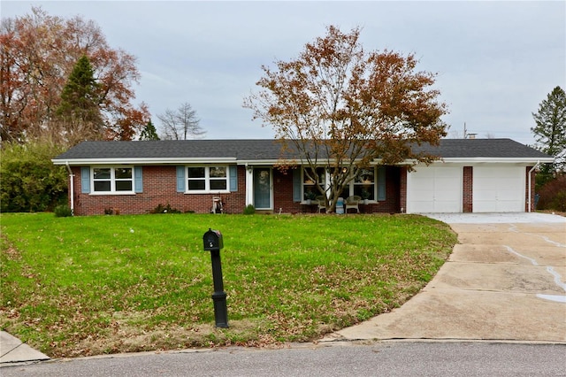 ranch-style home featuring a garage and a front lawn