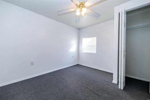 unfurnished bedroom with ceiling fan, a closet, and dark colored carpet