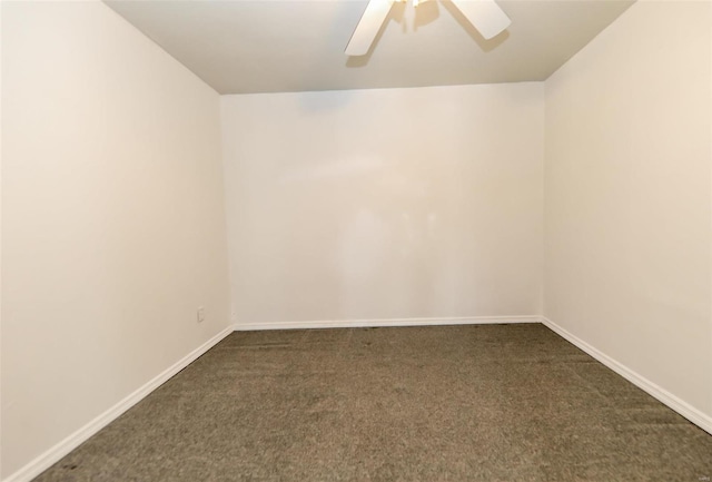 empty room featuring dark colored carpet and ceiling fan