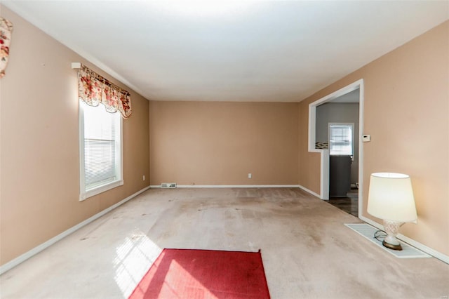 carpeted spare room with a healthy amount of sunlight