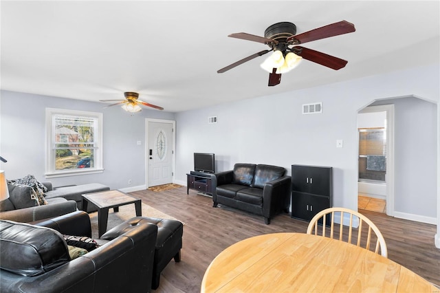 living room featuring hardwood / wood-style floors and ceiling fan