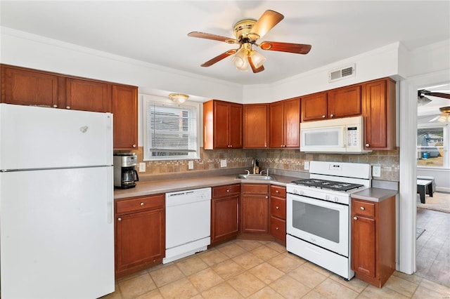 kitchen featuring decorative backsplash, ornamental molding, white appliances, ceiling fan, and sink