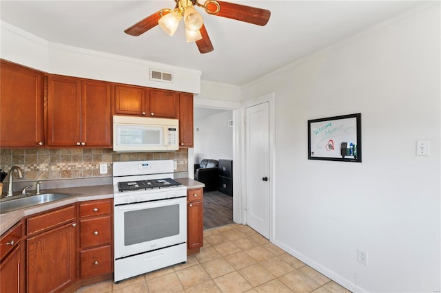 kitchen with tasteful backsplash, ornamental molding, white appliances, ceiling fan, and sink