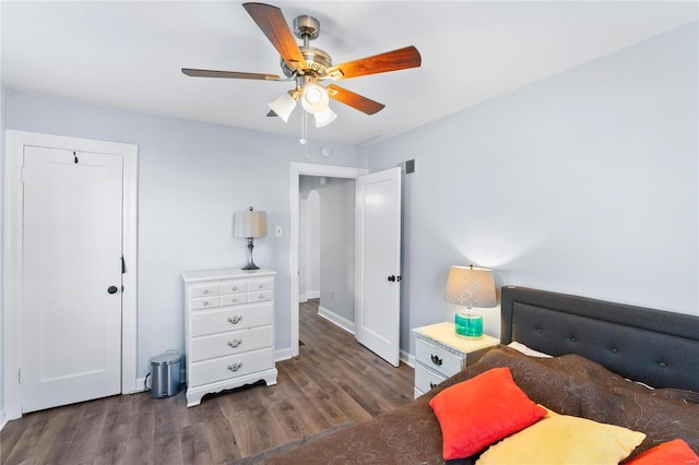 bedroom featuring a closet, ceiling fan, and dark hardwood / wood-style flooring