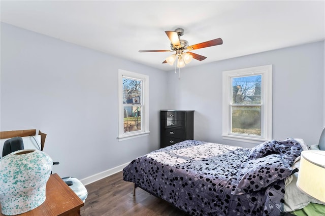 bedroom with ceiling fan and dark wood-type flooring