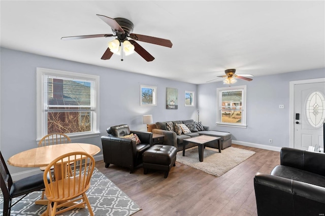 living room featuring hardwood / wood-style floors and ceiling fan