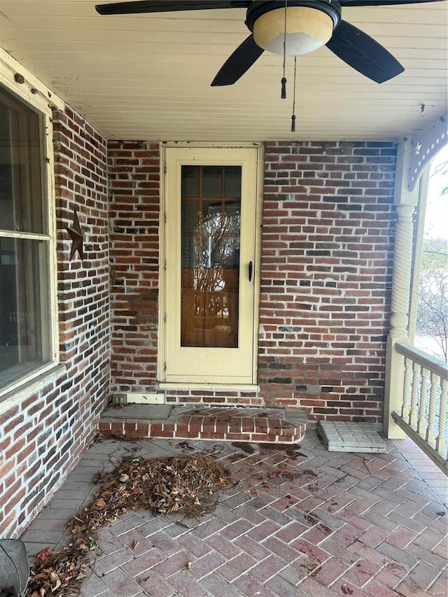 view of exterior entry with ceiling fan