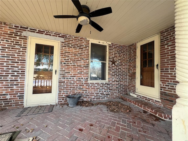 view of exterior entry featuring a patio and ceiling fan