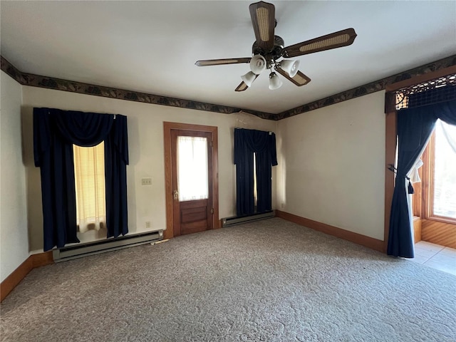 spare room with carpet flooring, a healthy amount of sunlight, and baseboard heating