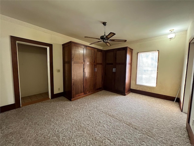 unfurnished bedroom featuring light colored carpet and ceiling fan