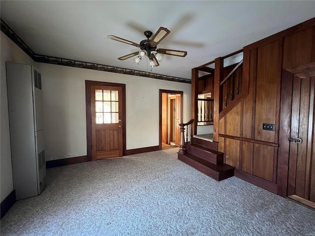 carpeted foyer with ceiling fan