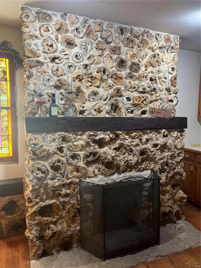 interior details with hardwood / wood-style flooring and a fireplace