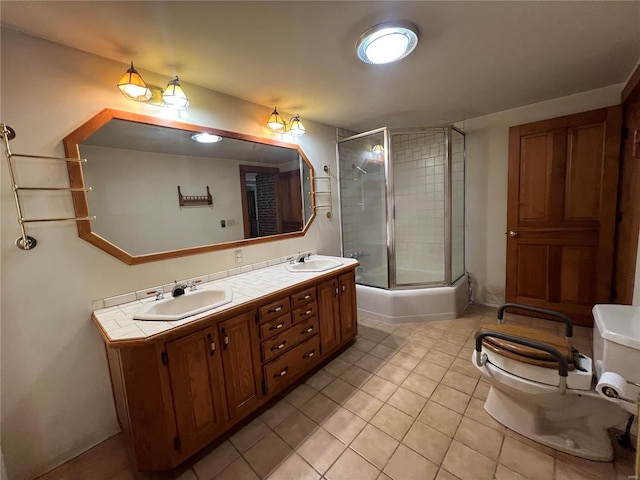 full bathroom featuring tile patterned floors, vanity, toilet, and enclosed tub / shower combo