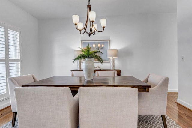 dining room featuring light hardwood / wood-style floors and an inviting chandelier