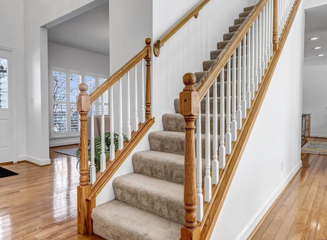 staircase with hardwood / wood-style flooring