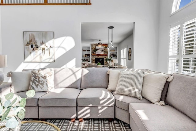 living room with built in shelves and a fireplace