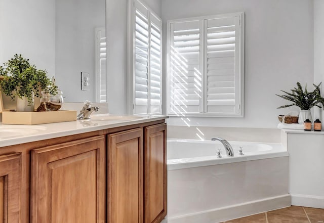 bathroom featuring a bathtub, tile patterned floors, and vanity