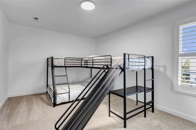 carpeted bedroom featuring multiple windows