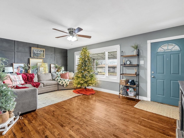 living room featuring ceiling fan and hardwood / wood-style flooring