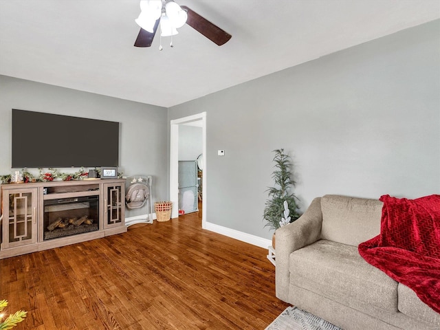 living room featuring ceiling fan and wood-type flooring