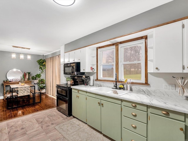 kitchen featuring light wood-type flooring, white cabinetry, black appliances, and sink