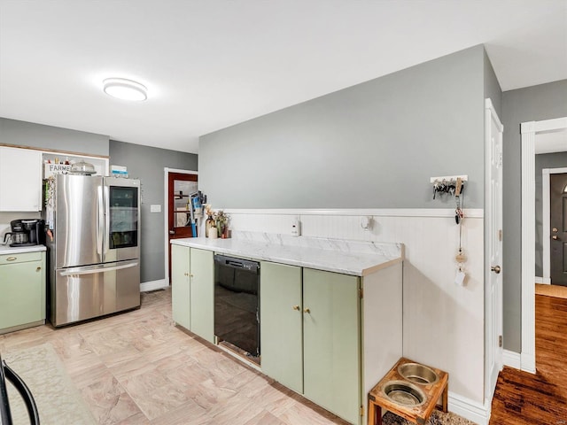 kitchen featuring dishwasher, stainless steel fridge, green cabinets, and light hardwood / wood-style flooring