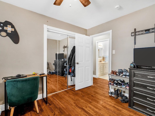 interior space with hardwood / wood-style floors, ceiling fan, and a closet