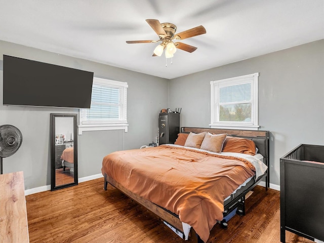 bedroom with hardwood / wood-style floors and ceiling fan