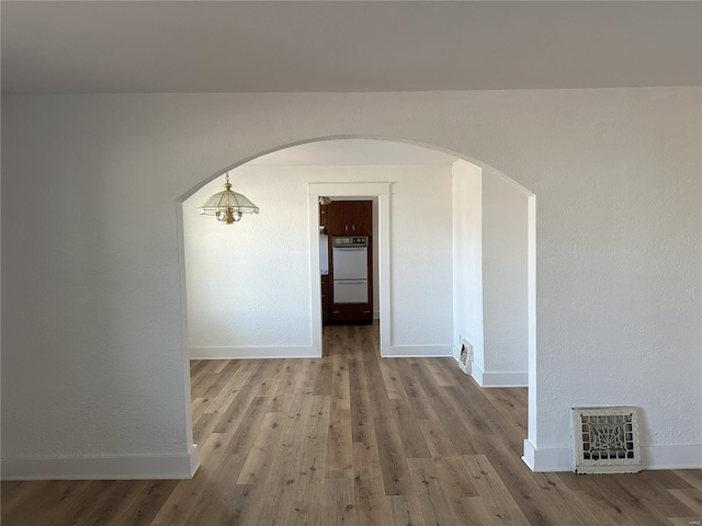 corridor with wood-type flooring